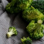 Green Broccoli on White Textile