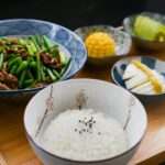 Rice on Bowl, Sliced-egg, Corn, and Vegetable on Table