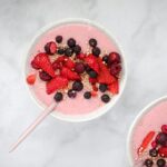 red and black berries in white ceramic bowl